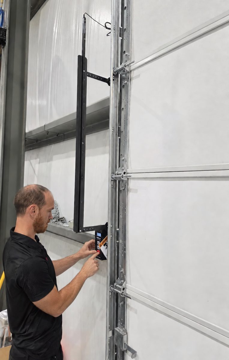 Technician programming a commercial garage door operator