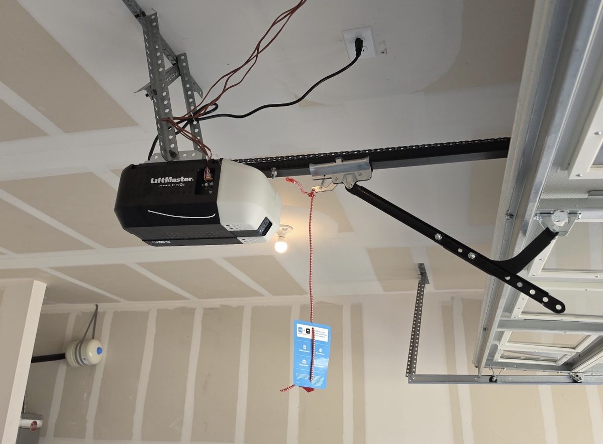 Newly installed LiftMaster chain-drive opener and rail in a finished garage