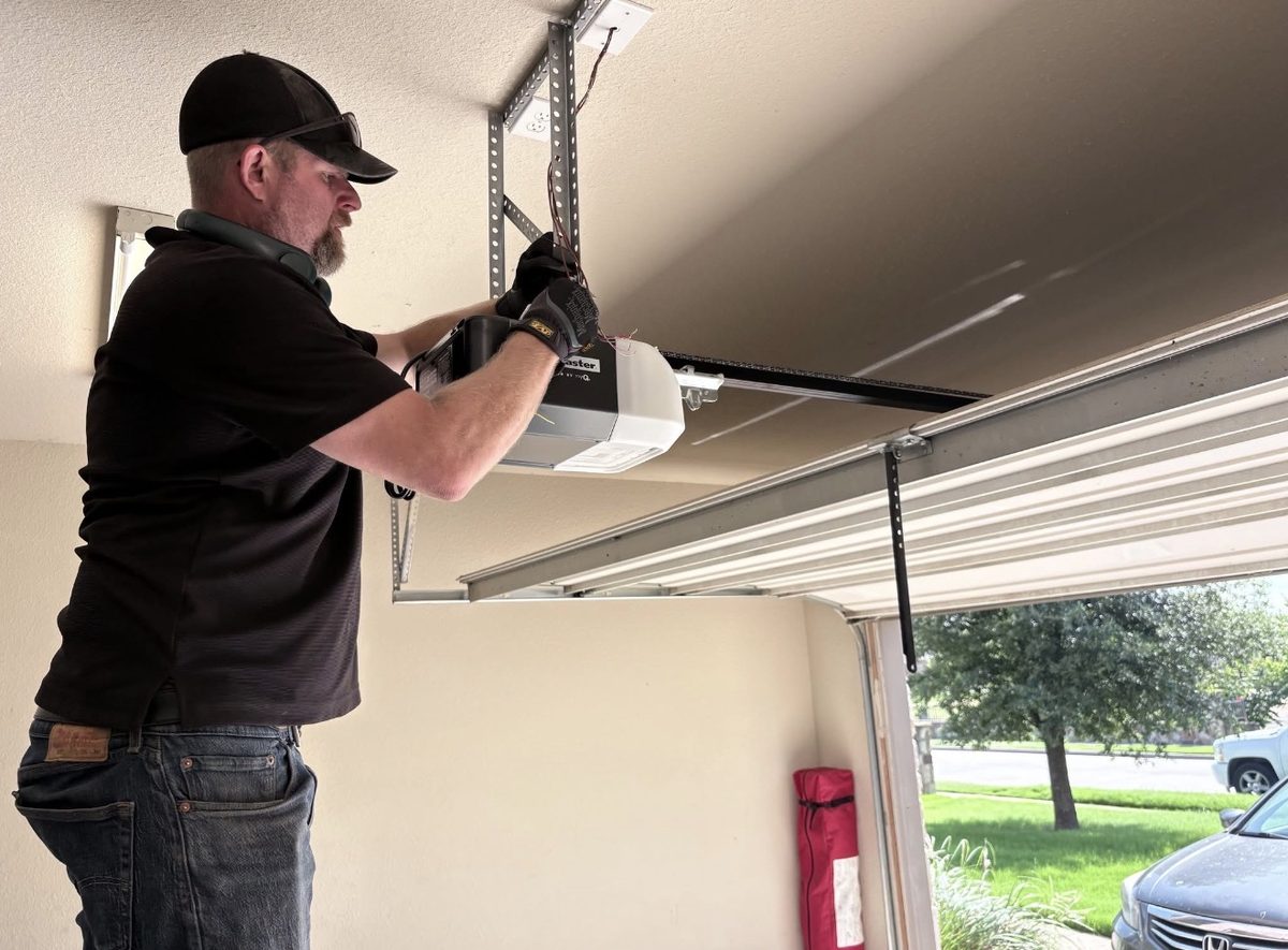 Technician rewiring a LiftMaster garage door opener
