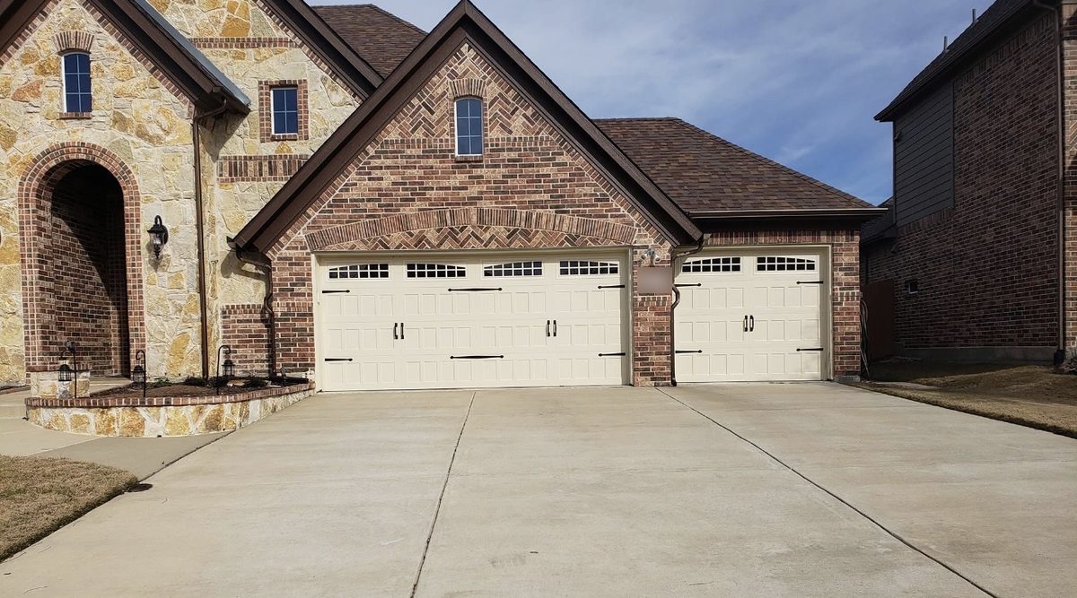 Almond garage doors with window tops and decorative handles and hinges