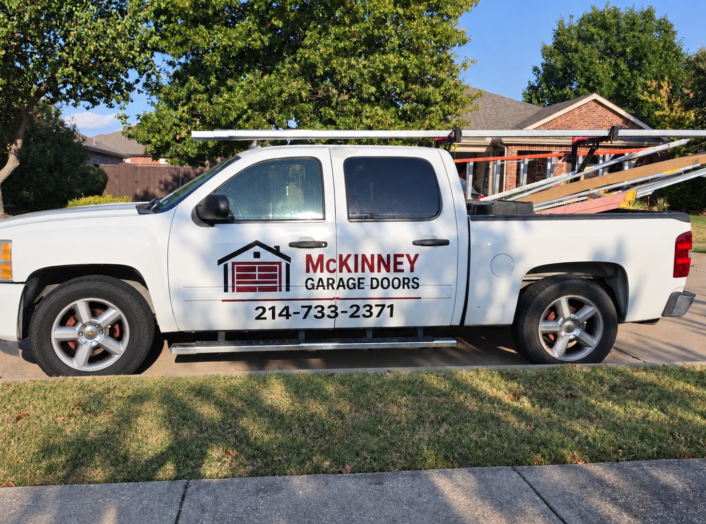 McKinney Garage Doors service truck with ladder rack, parked on a residential street in McKinney, Texas